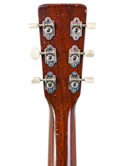 Close-up of the headstock of a 1954 Vintage Martin 00-17 acoustic guitar, featuring intricate details and timeless style.