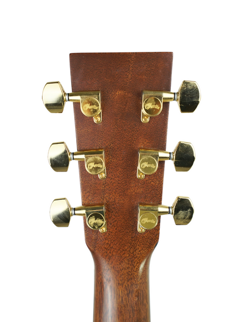 Close-up of the neck of a Martin OMC-PA1 acoustic guitar from 2011, featuring brass knobs for tuning adjustments.