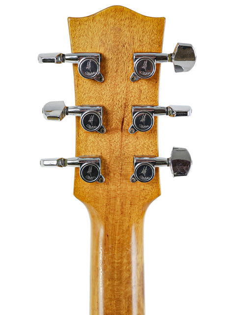 Close-up of the neck of a Maton M225 acoustic guitar, crafted in Australia in 1996, displaying its beautiful wood grain.