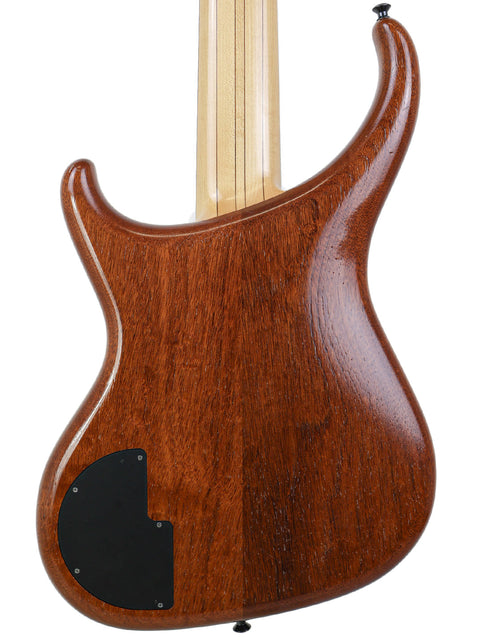 Close-up of the rear body of the Alembic Orion bass guitar, showing the smooth mahogany finish and rear electronics cover.