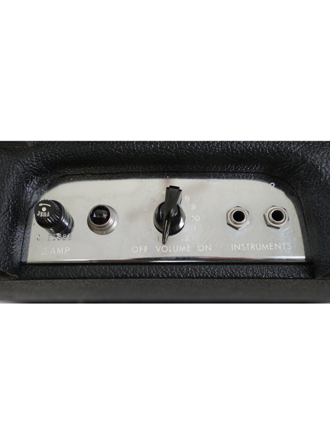  Close-up shot of the control panel on a 1964 Fender Champ 5F1 amplifier, highlighting its vintage design and features.