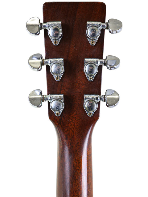 Close-up shot of the headstock from a 1974 Martin D-18 acoustic guitar, featuring its iconic vintage style.