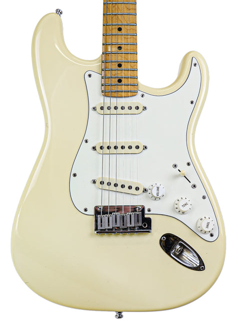 Cream-colored electric guitar with maple neck and white pickguard.