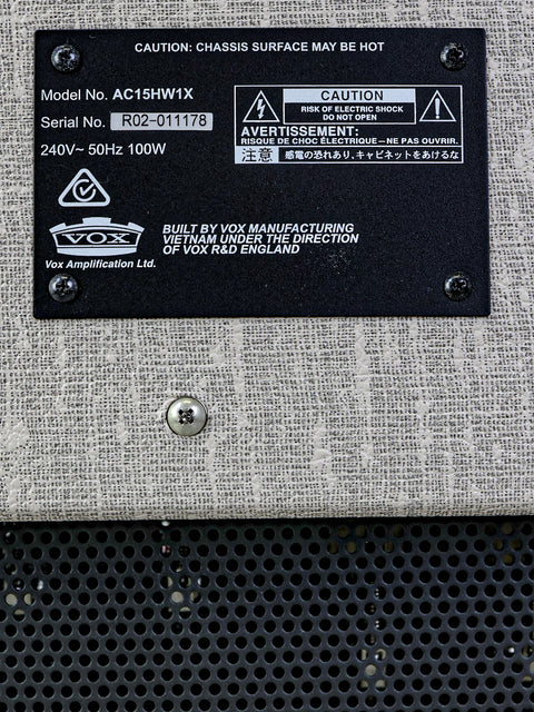 Detailed shot of a metal box with a label reading "Vox AC-15 HW1X - 2021," highlighting its unique features and finish.