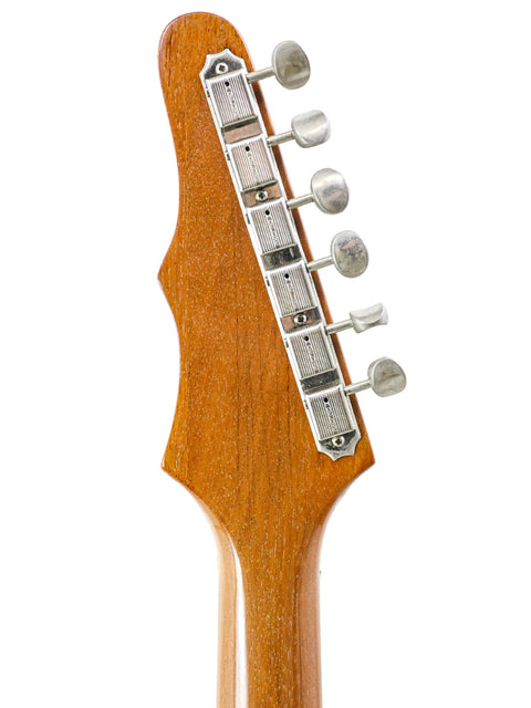 Detailed view of a 1964 Epiphone Crestwood Custom guitar headstock, showcasing its wooden body and classic design.