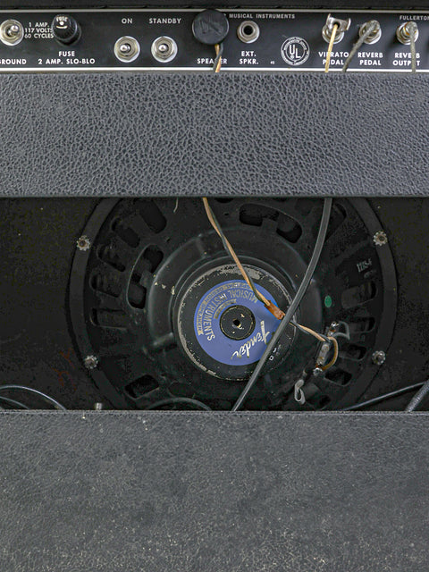 Detailed view of a 1967 Fender Deluxe Reverb Blackface combo amplifier showcasing its speaker.