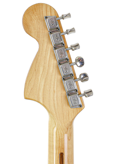 Detailed view of a 1974 USA Fender Stratocaster guitar head with a pickup, highlighting its vintage aesthetic and quality.