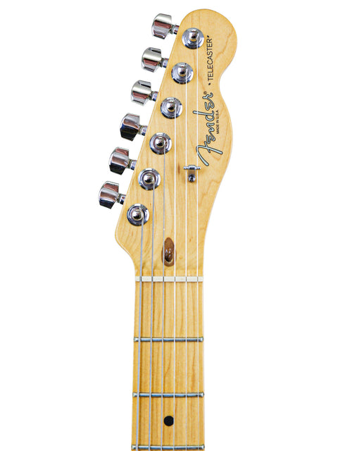 Detailed view of a 1999 Fender Tele Plus V2 guitar, prominently displayed on a white background, highlighting its craftsmanship.
