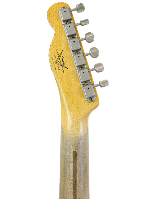 Detailed view of a Fender Custom Shop '53 Telecaster Heavy Relic guitar head, highlighting the wooden body craftsmanship.