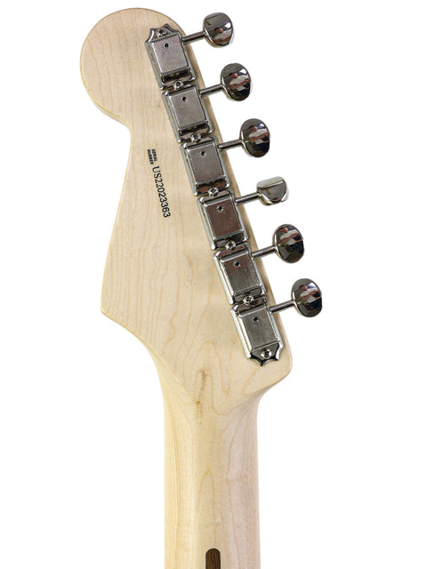 Detailed view of a Fender Eric Clapton "Blackie" Stratocaster guitar head, highlighting the wooden body and elegant design.

