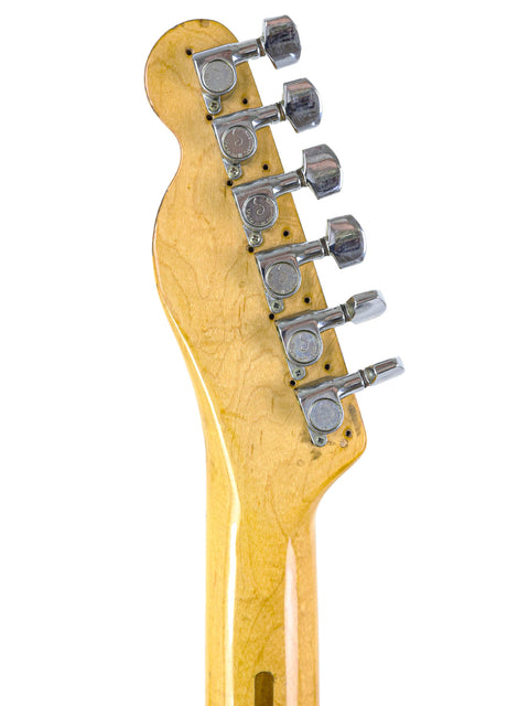 Detailed view of a yellow Fender Telecaster Custom guitar neck, USA-made in 1977, highlighting its unique finish and design.