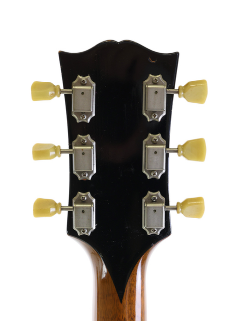 Detailed view of the headstock from a 1952 Gibson ES-300 electric guitar, highlighting its vintage charm and intricate features.