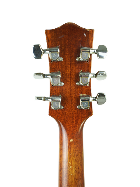 Detailed view of the headstock from a 1972 Maton FG100 acoustic guitar, highlighting its vintage charm and unique features.
