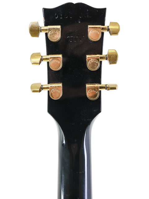 Detailed view of the headstock from a 2001 Gibson Chet Atkins SST electric guitar, highlighting its unique features and finish.