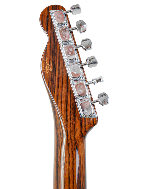 Detailed view of the headstock from a 2003 Fender Masterbuilt Telecaster, highlighting its rosewood design and unique features.
