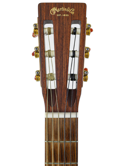 Detailed view of the headstock from a 2003 Martin 000C-16SGCTNE acoustic guitar, highlighting the craftsmanship and tuning mechanisms.