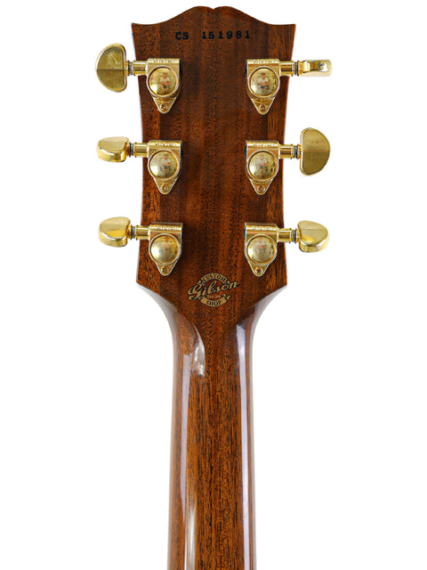 Detailed view of the headstock from a 2011 Gibson Custom Shop ES-355 acoustic guitar, highlighting the gold hardware.
