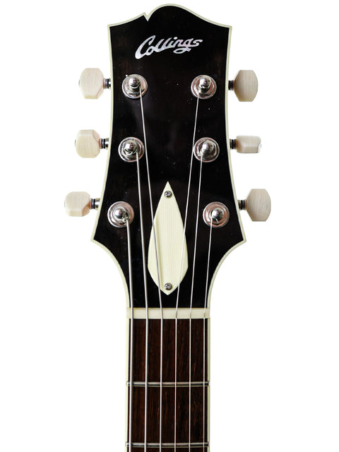 Detailed view of the headstock from a 2019 Collings CL Deluxe electric guitar, highlighting its premium materials and finish.