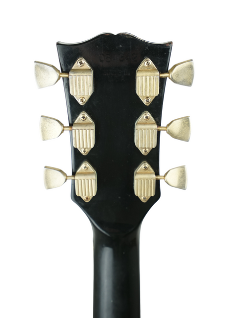 Detailed view of the headstock of a 1973 Gibson Les Paul Custom Black Beauty, highlighting its vintage features and elegance.