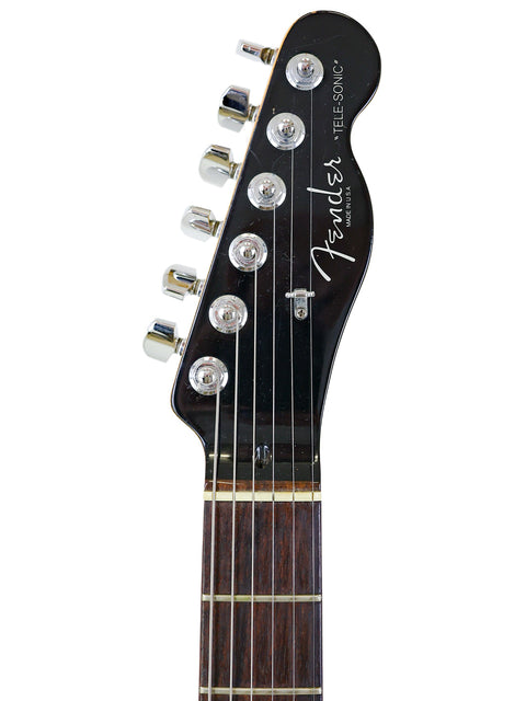 Detailed view of the headstock of a 2001 Fender Tele-Sonic electric guitar, highlighting its unique features and finish.
