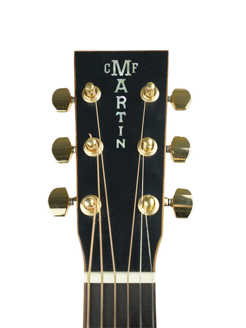 Detailed view of the headstock of a Martin OMC-PA1 acoustic guitar, showcasing the brand name "Martin."