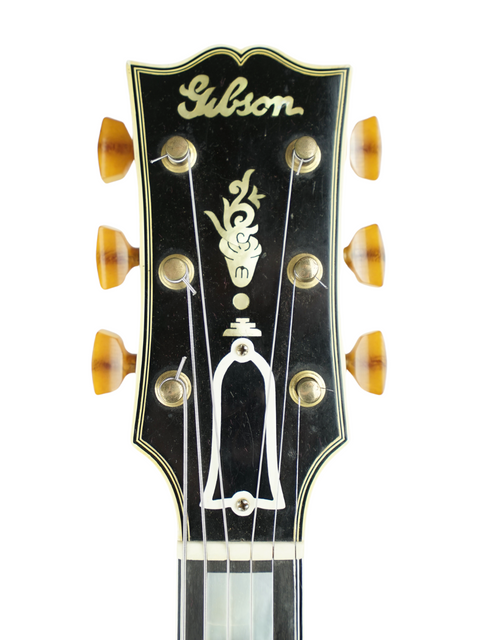 Detailed view of the headstock on a 1939 vintage Gibson L-5 electric guitar, highlighting its unique features and style.