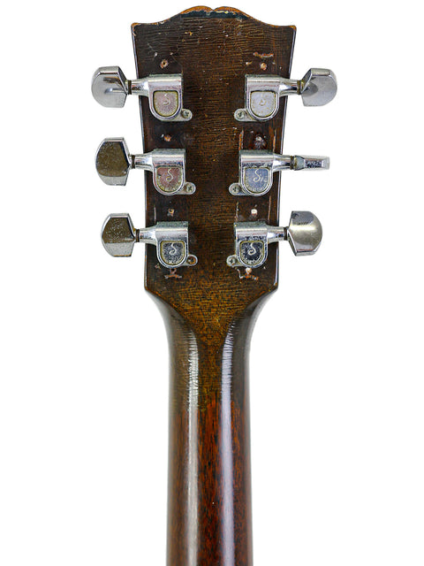 Detailed view of the headstock on a 1948-52 Gibson ES-125 acoustic guitar, reflecting vintage American craftsmanship.