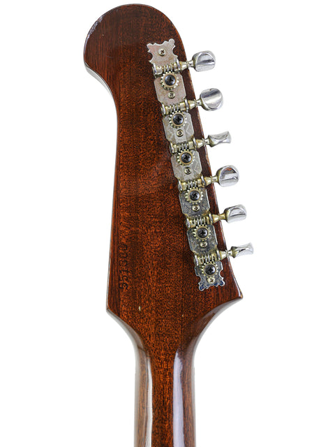 Detailed view of the headstock on a 1966 Vintage Gibson Non Reverse Firebird III, emphasizing its wooden body.