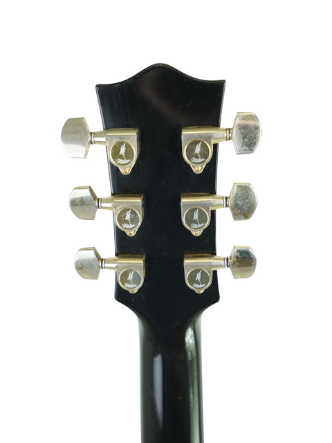 Detailed view of the headstock on a 1989 Maton Tommy Emmanuel 'Ebony' Signature electric guitar, highlighting its craftsmanship.