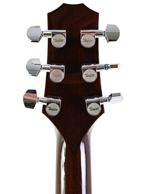 Detailed view of the headstock on a 2007 Taylor Solid Body acoustic guitar, highlighting its elegant features and finish.