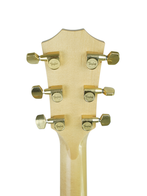 Detailed view of the headstock on a 2011 Taylor 616ce acoustic guitar, highlighting its beautiful wood and tuning pegs.
