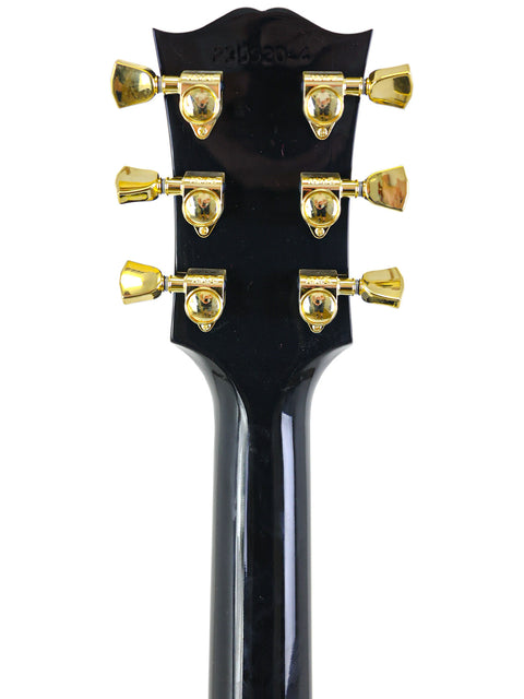 Detailed view of the headstock on a Gibson Custom Shop Elvis Dove electric guitar, highlighting its unique features and finish.