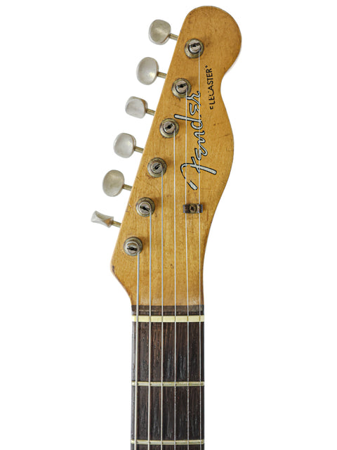 Displayed in the photo is a vintage 1963 Fender Stratocaster, exemplifying the timeless elegance of this legendary guitar.