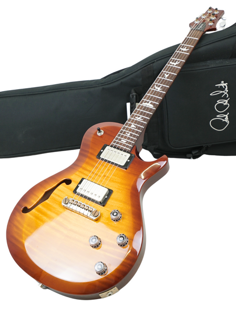 Displaying a 2018 PRS S2 Singlecut Semi-Hollow guitar with a case and strap, illustrating its premium quality.