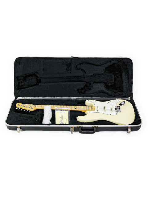 Electric guitar in a black case on a white background.