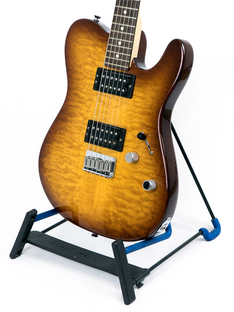Electric guitar with a quilted maple top on a stand.