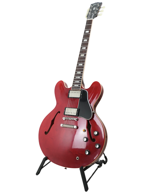 Eye-catching red electric guitar, the Gibson Yamano Export ES-335 Block '63 Reissue, displayed elegantly on a stand.