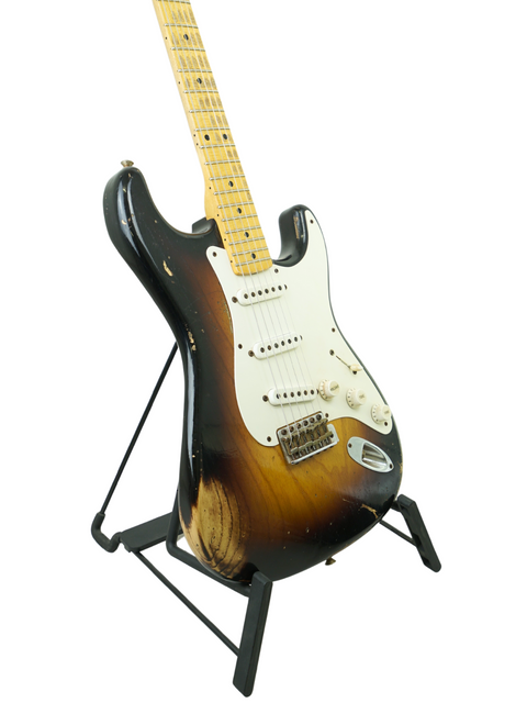 Fender Custom Shop '54 Stratocaster Relic guitar on a stand against a clean white background, celebrating 60 years of craftsmanship.
