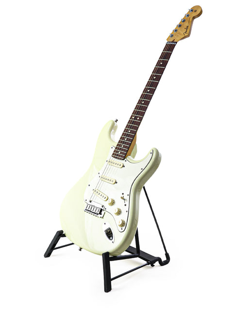 Fender Custom Shop Jeff Beck Signature Stratocaster in white, resting on a stand with a contrasting black base.