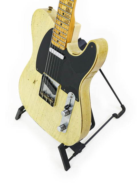 Fender Custom Shop Nocaster guitar on a stand, showcasing its craftsmanship against a clean white background.
