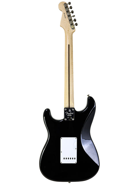 Fender Eric Clapton "Blackie" Stratocaster in black, highlighted by a white pickup, representing classic rock style.