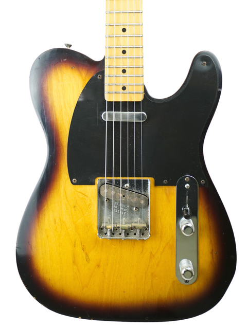 Fender Telecaster guitar with a sunburst finish, showcasing its vintage style and craftsmanship from the Custom Shop 2012.