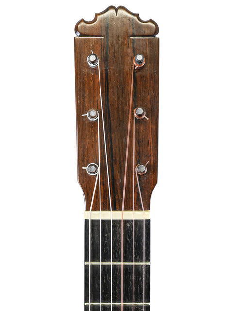 Focused shot of an acoustic guitar neck, emphasizing its craftsmanship and texture, with a nod to Spain, 1973.