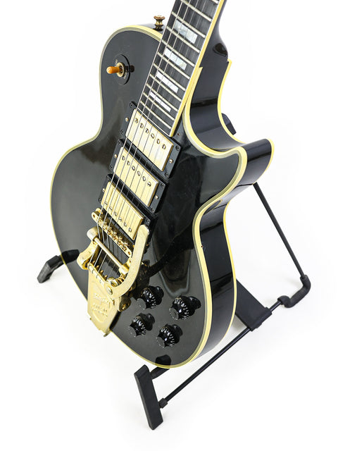 Gibson Custom Shop 1957 Les Paul Custom B3 'Black Beauty' Reissue, a black electric guitar with striking gold hardware, 2004.
