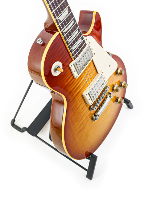 Gibson Custom Shop 1959 Reissue Les Paul R9 guitar on a stand against a clean white background.