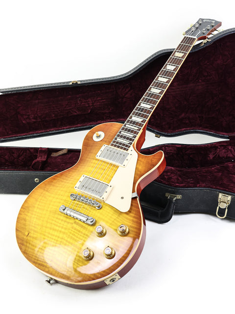 Gibson Les Paul '59 Reissue guitar with its case, set on a bright white background for emphasis.