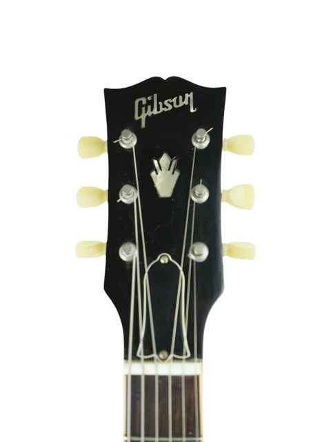  Gibson Les Paul Custom 1964 guitar, showcasing its classic design and rich finish, alongside a 2012 Gibson Custom ES-335 Iced Tea.
