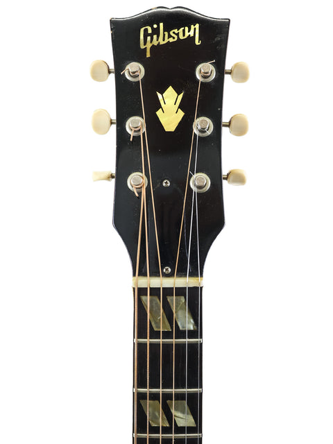 Gibson Les Paul Custom '59 guitar, exemplifying vintage style, next to a 1964 Southern Jumbo model from the USA.
