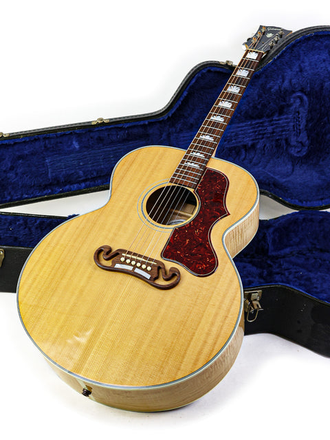 Gibson SJ-150 guitar resting in a blue case, showcasing its elegant design and craftsmanship from 2008.
