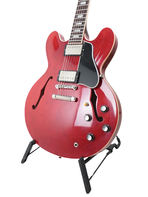 Gorgeous red electric guitar, Gibson Yamano Export ES-335 Block '63 Reissue, showcased on a stand for sale or display.